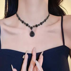 Close-up of elegant black rhinestone necklace with a teardrop pendant worn on model