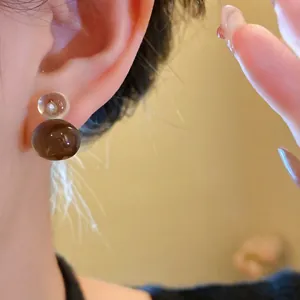 Minimalist resin gourd-shaped stud earrings with silver needles in jelly brown and clear
