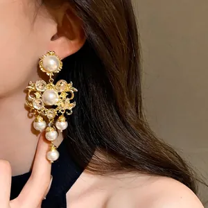 Elegant vintage baroque gold drop earrings with white pearls and sparkling crystals