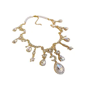 Vintage gold necklace with heart and moon pendants, pearls and large teardrop crystals