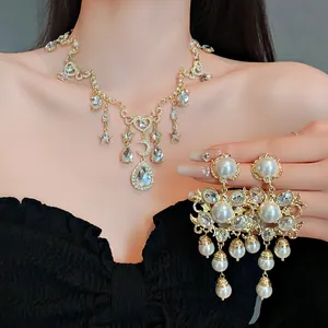 Close-up detail of vintage style heart moon necklace with matching pearl chandelier earrings