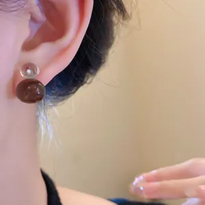 Minimalist resin jelly color gourd earrings worn on ear for a chic and elegant look.