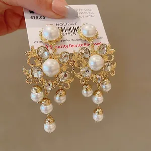 Exaggerated vintage gold-plated drop earrings with glossy pearls and sparkling crystals