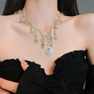 Detail view of retro gold-tone heart and moon necklace with sparkling crystal charms