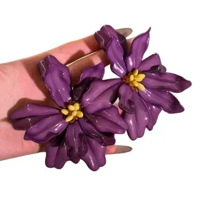 Oversized purple acrylic flower earrings with yellow beads for a tropical holiday look.
