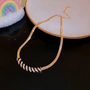 Elegant gold plated curved necklace with black enamel and sparkling rhinestones detail