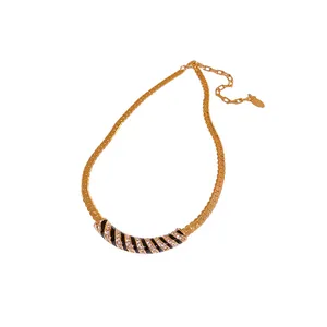 Elegant gold plated curved necklace featuring black enamel stripes and pave crystals