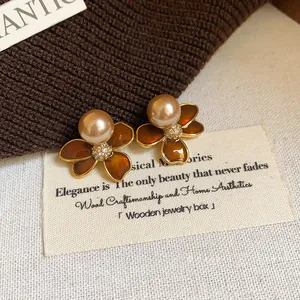 Elegant real gold plated flower stud earrings with brown enamel and pearl accents.