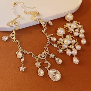 Macro view of vintage gold necklace with pearls, rhinestones, moon and stars
