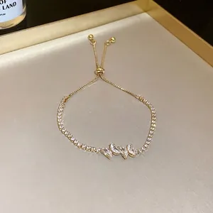 Elegant gold-tone slider bracelet featuring butterfly-shaped cubic zirconia accents
