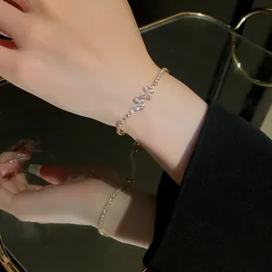 Close-up of sparkling zircon butterfly pull-out bracelet with elegant mirror reflection