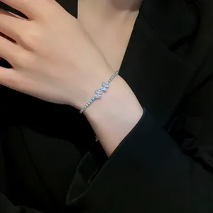 Elegant zircon butterfly bracelet with adjustable tennis chain shown on female wrist.