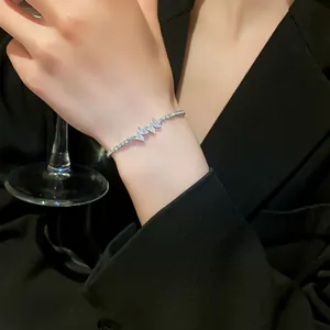 Close-up view of an elegant silver zircon butterfly adjustable tennis bracelet on wrist