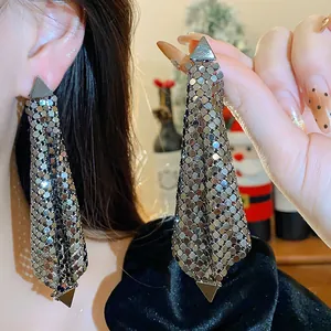 Detailed macro shot of luxury silver mesh drape earrings with geometric triangle top