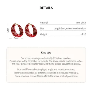 Detailed view of red paisley fabric hoop earrings showing material size and weight specs