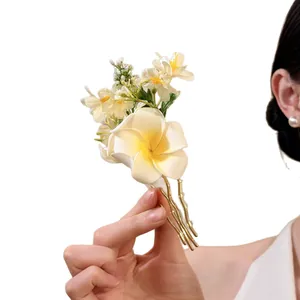 Elegant fabric plumeria hair pin with gold metal fork for versatile styling.