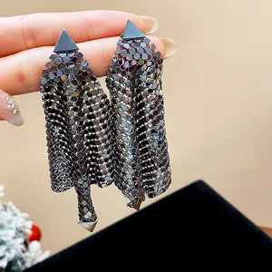 Close-up detail of gunmetal metallic mesh tassel earrings with triangular stud design