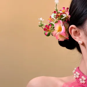 Detailed macro view of an elegant pink fabric flower hair pin with pearl accents