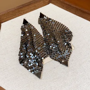 Detailed macro view of gunmetal mesh drop earrings with geometric triangular accents