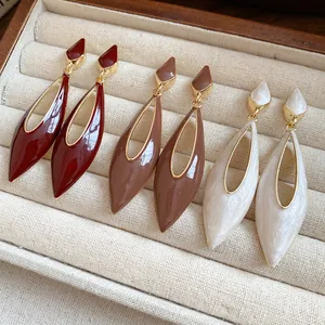 Detail view of retro Maillard style drip oil hollow teardrop dangle earrings in three colors