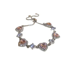 Elegant silver-toned heart bracelet featuring pink cubic zirconia and adjustable bolot clasp