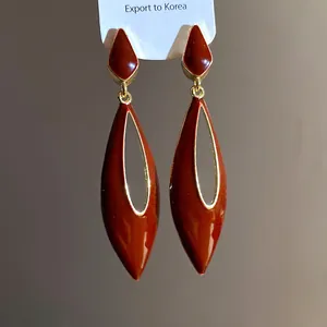 Macro view of Maillard brown enamel finish on these hollow teardrop earrings