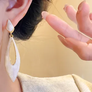 Elegant vintage white enamel hollow teardrop dangle earrings with gold-plated trim