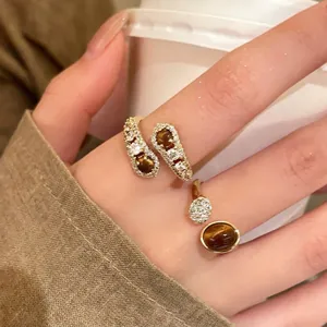 Gros plan d'une bague torsadée plaquée or avec œil de tigre et pierres en zircon