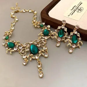Vintage palace style gold necklace and earrings set with green teardrop crystals