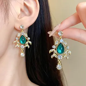 Vintage court style gold earrings with green waterdrop stone and leaf diamond accents