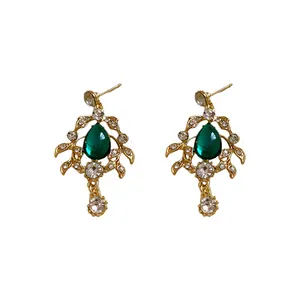 Vintage gold-tone earrings featuring teardrop green gems and sparkling rhinestones