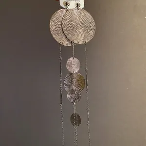 Elegant silver tassel earrings with textured round metal discs for women