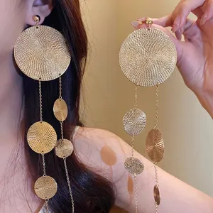 Exaggerated golden textured metal disc tassel drop earrings for women