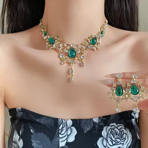 Detailed view of vintage emerald green teardrop pendant necklace and matching earrings set