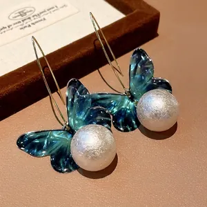 Elegant forest style butterfly pearl drop earrings with translucent teal wings