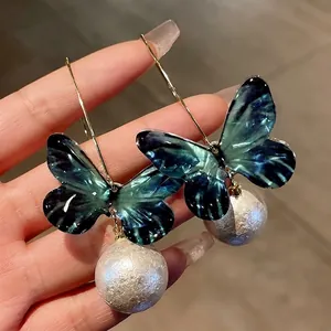 Forest style butterfly pearl drop earrings with long gold hooks