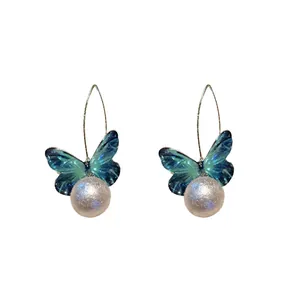 Elegant fairy-style butterfly earrings with shimmering pearl drops and silver hooks.