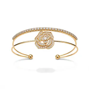 Elegant gold double-layer open cuff bracelet featuring a zircon-encrusted rose flower motif.