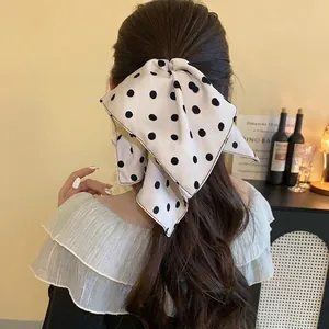 Elegant white polka dot bow hair clip accessory for women with a gentle and stylish aesthetic