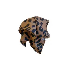 Elegant leopard print fabric hair accessory for versatile styling on white background
