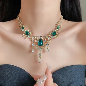 Vintage palace style necklace featuring green waterdrop rhinestone pendants on model neck