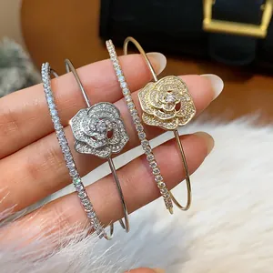 Detailed shot of elegant zircon rose flower double-layer open bangles in gold and silver