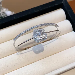 Detailed view of a silver double-layer bangle featuring a sparkling zircon rose motif