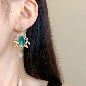 Elegant vintage gold-tone earring with green teardrop stone and sparkly rhinestones