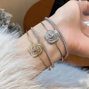 Detail of elegant zircon flower open bracelets and sparkling tennis bracelets on wrist