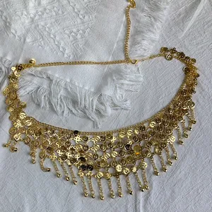 Detailed view of a golden ethnic coin waist chain belt with intricate tassel fringe