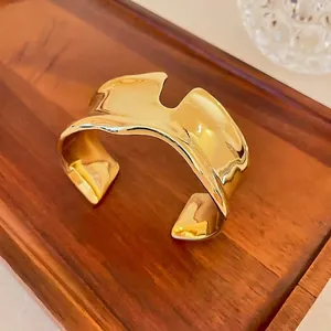 Statement bold gold liquid irregular open cuff bracelet with minimalist metallic finish