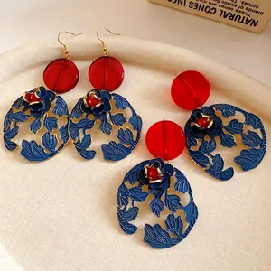Vintage Chinese style floral drop earrings with red resin beads and blue enamel petals.