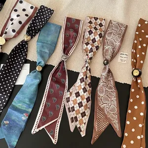 Detailed view of vintage patterned fabric scarf necklaces with metallic clasps