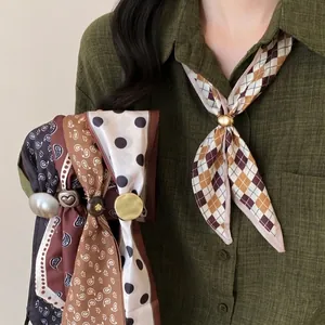 Detail view of retro plaid and polka dot fabric scarf necklaces with metal ring buckles